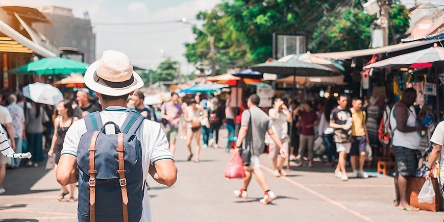 Man walking at Chatuchak Weekend Market in Bangkok.