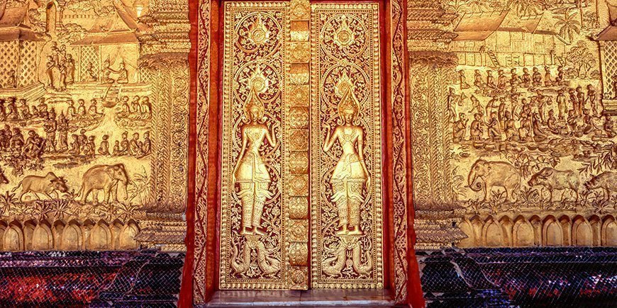 Gold-plated, ornate facade of Wat Mai Temple in Luang Prabang