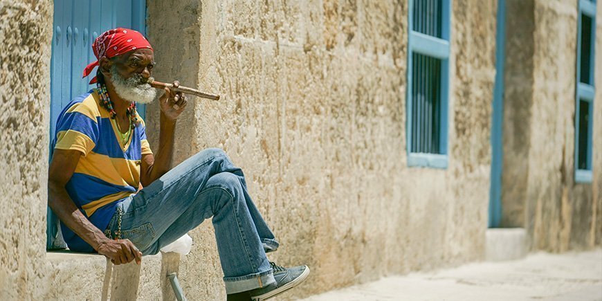 Old man sitting with a big cigar in Havana, Cuba