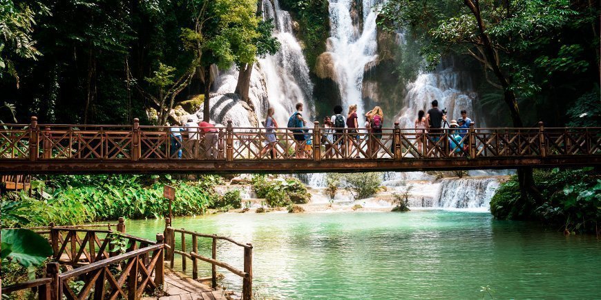 People walking on bridge at Kuang Si waterfalls