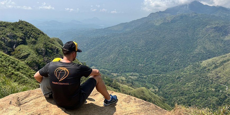 Father and son sitting on top of Little Adam's Peak in Sr Lanka