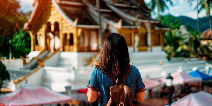 Woman looking at temple in Luang Prabang, Laos 