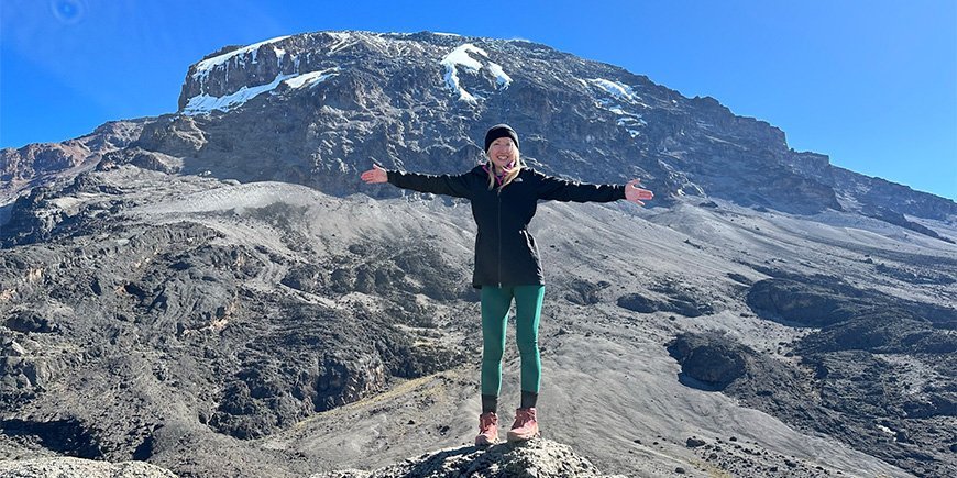 Catriona standing with view to the wild landscapes of Kilimanjaro