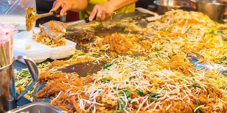 Pad Thai being prepared at street food stall in Thailand