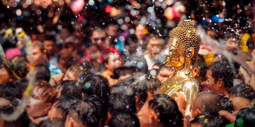 Golden Buddha being sprayed with water during the Songkran festival in Thailand