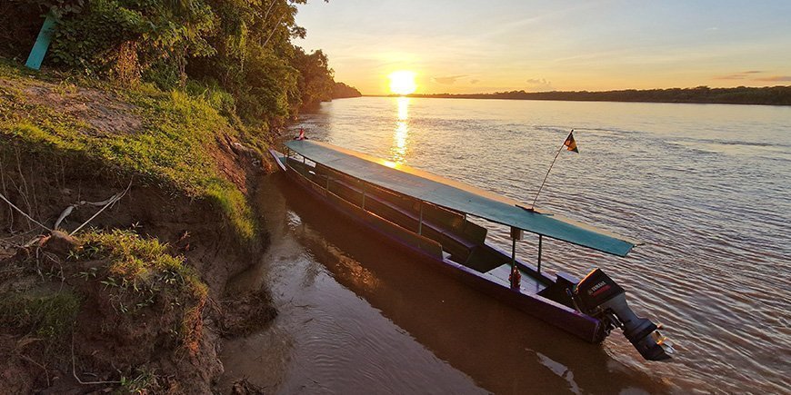 Boat on river in the Amazon rainforest