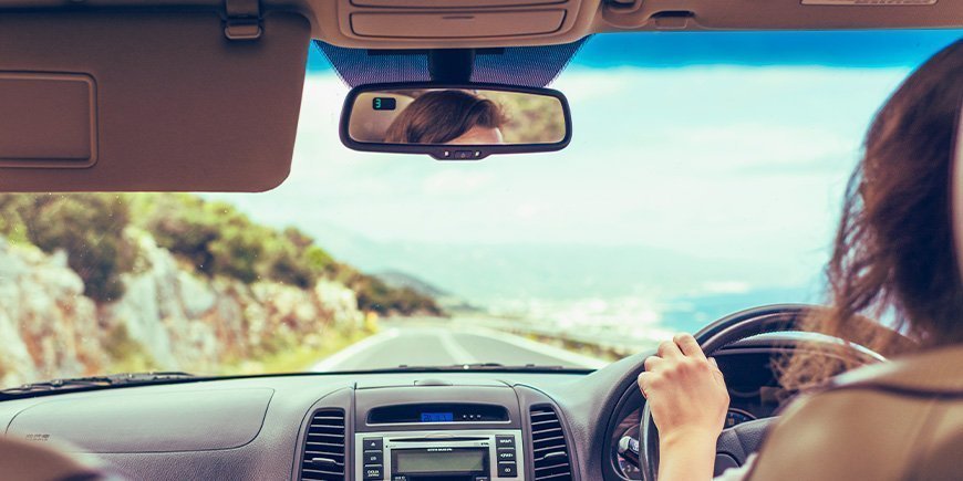 Woman driving on the left side of the road in Australia