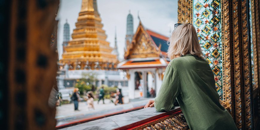 Woman looking at temple in Bangkok, Thailand