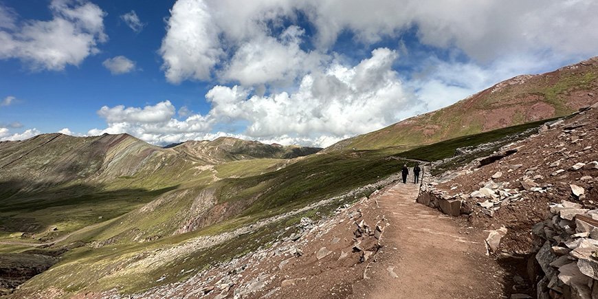 Two people hiking on Rainbow Mountain in Peru