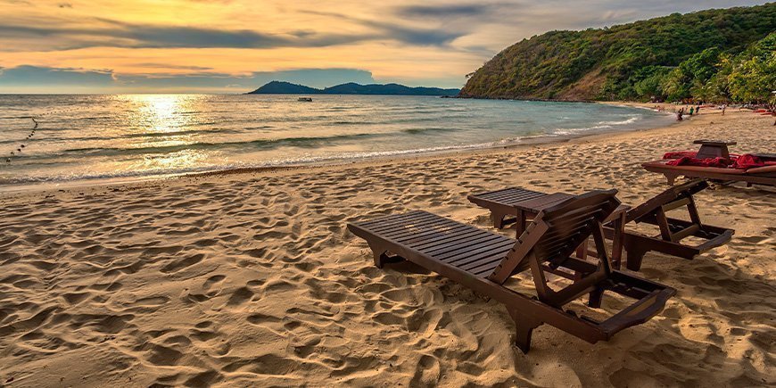 Sunset and sunbeds at Ao Prao Beach on Koh Samet, Thailand.