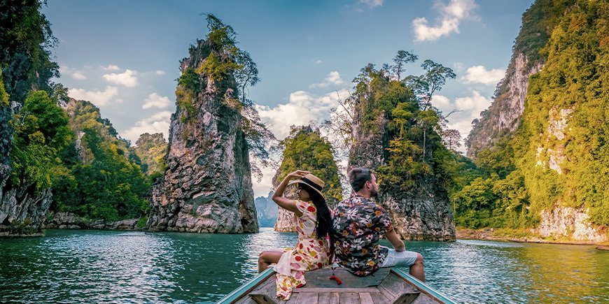 Woman and man sailing on the lake in Khao Sok National Park in Thailand