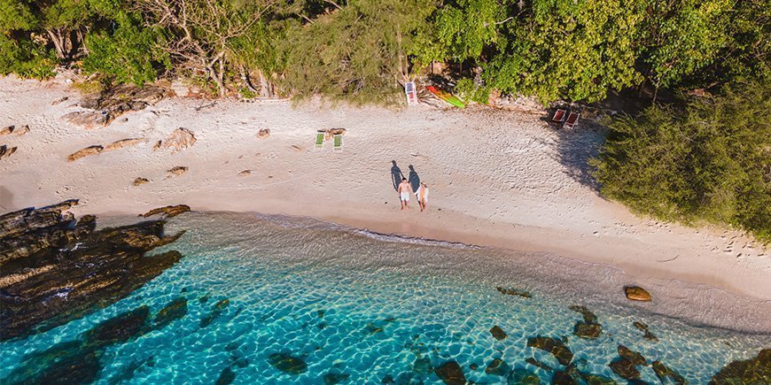 Couples holding hands on the beach on Koh Samet