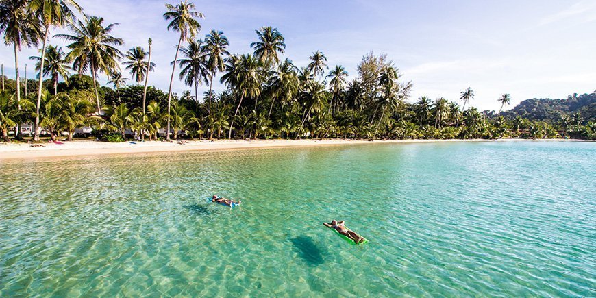 People relaxing in the water on the beach on Koh Kood