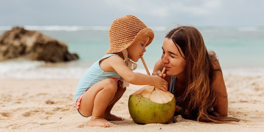 Young woman and child on a beach in Thailand