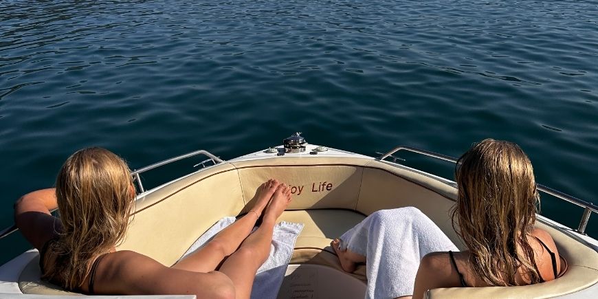 two women relaxing on a boat on Ilha Grande