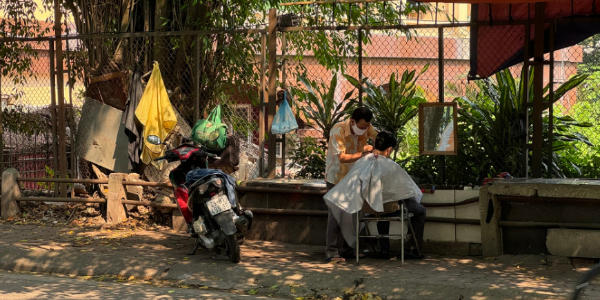 Man getting a haircut on the roadside