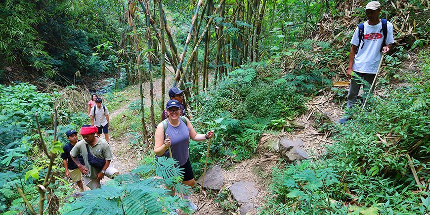 Hiking on the trail to red Coral Waterfall in Munduk in Bali