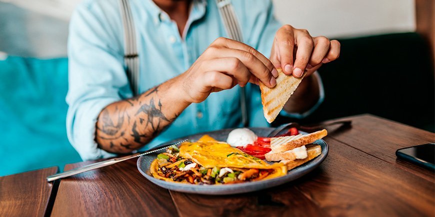 man eating American breakfast