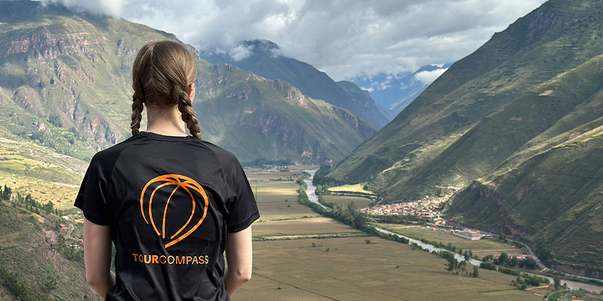 Woman wearing a TourCompass t-shirt exploring Cusco in Peru