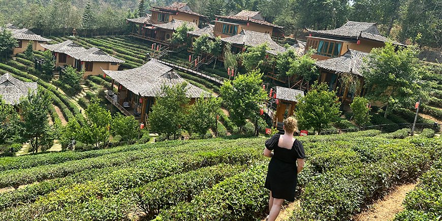 Michelle walks through the landscapes of Ban Rak Thai