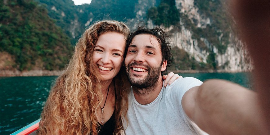 Man and woman take selfie on boat in Khao Sok National Park