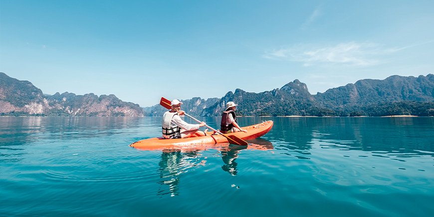 Father and son kayaking on the lake in Khao Sok National Park