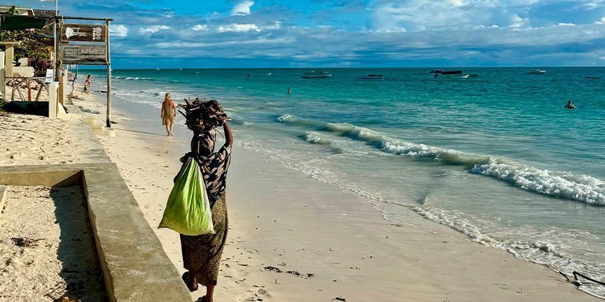 local woman walking on paje beach