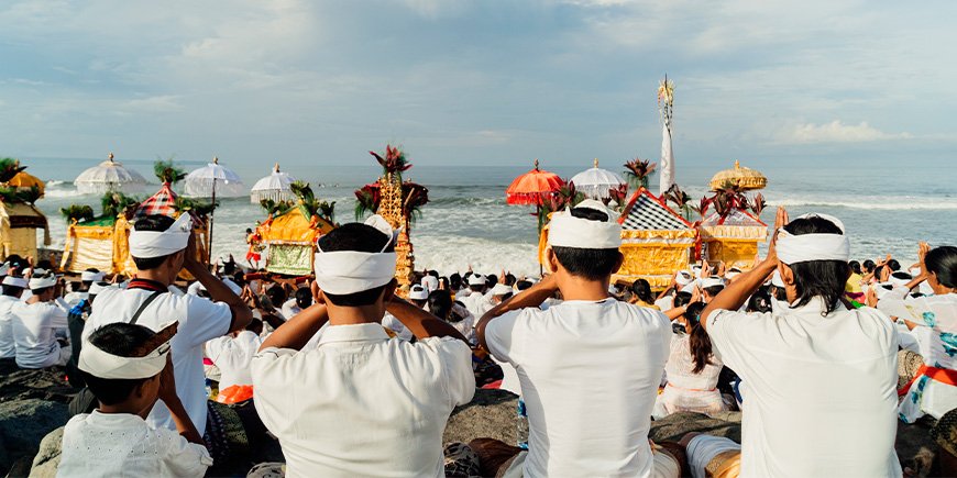 People walking towards the sea during Melasti in Bali. Nyepi in Bali