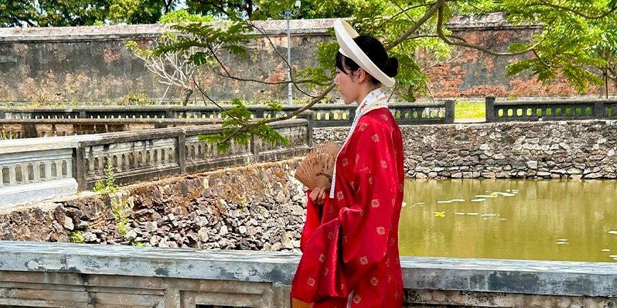 Woman dressed in beautiful clothes in the Imperial City in Hue, Vietnam